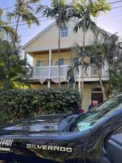 A silverado truck is parked in front of a house.