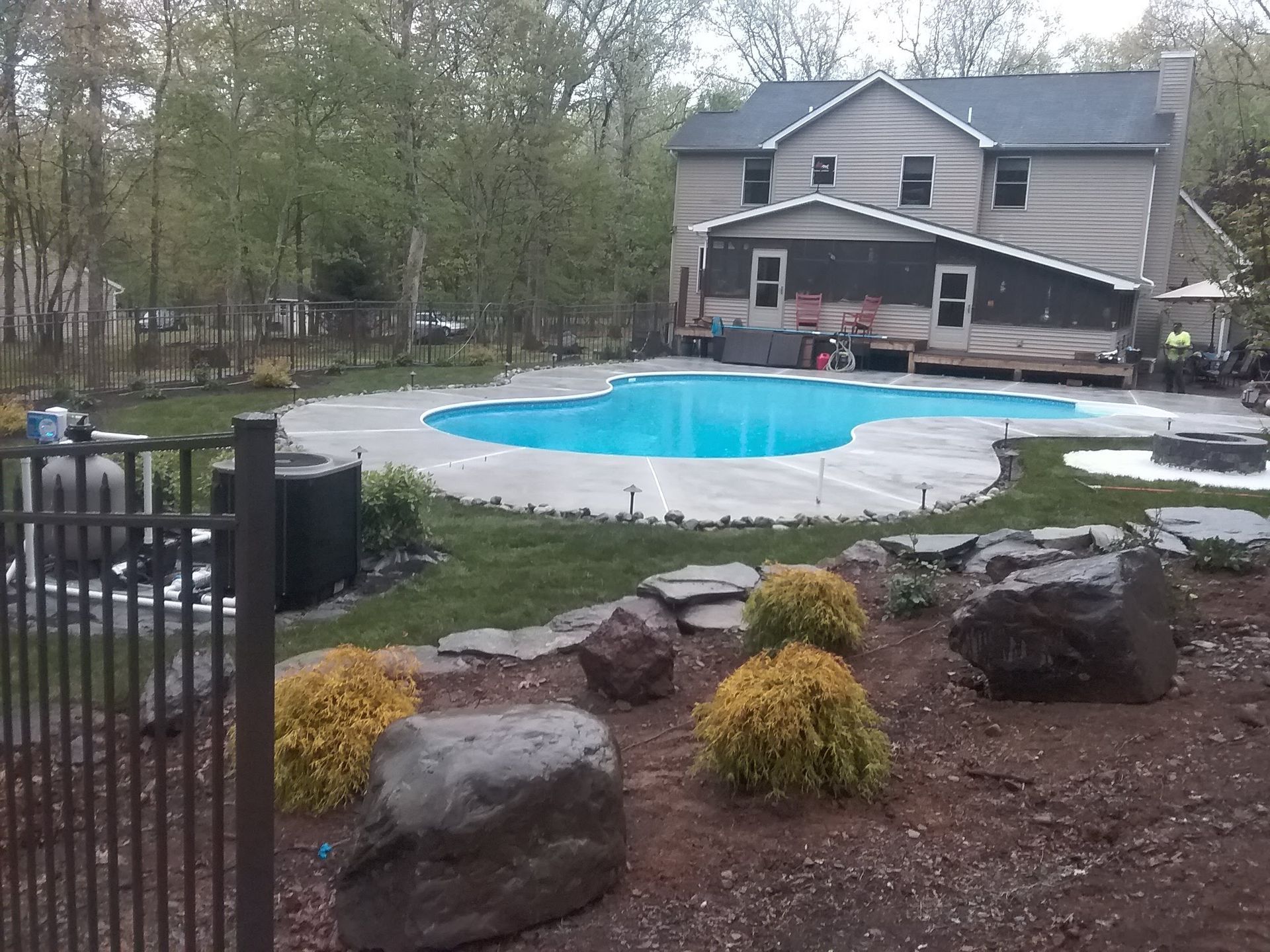 a house with a large swimming pool in front of it Landscaping by A.A.F Landscaping