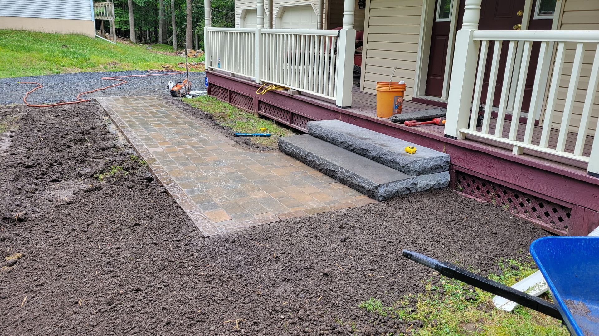 A walkway is being built in front of a house.