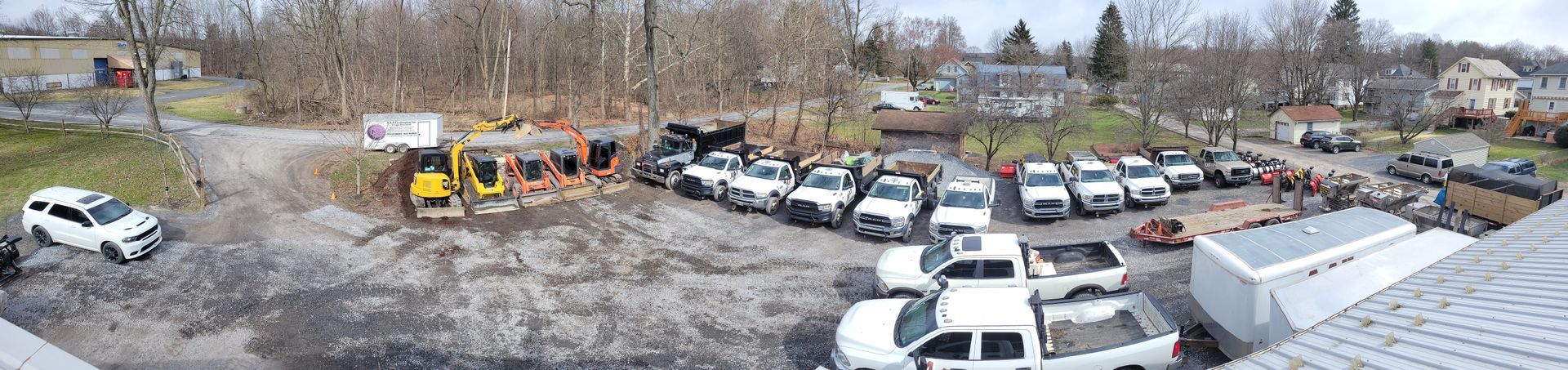 a bunch of trucks are parked in a lot .
