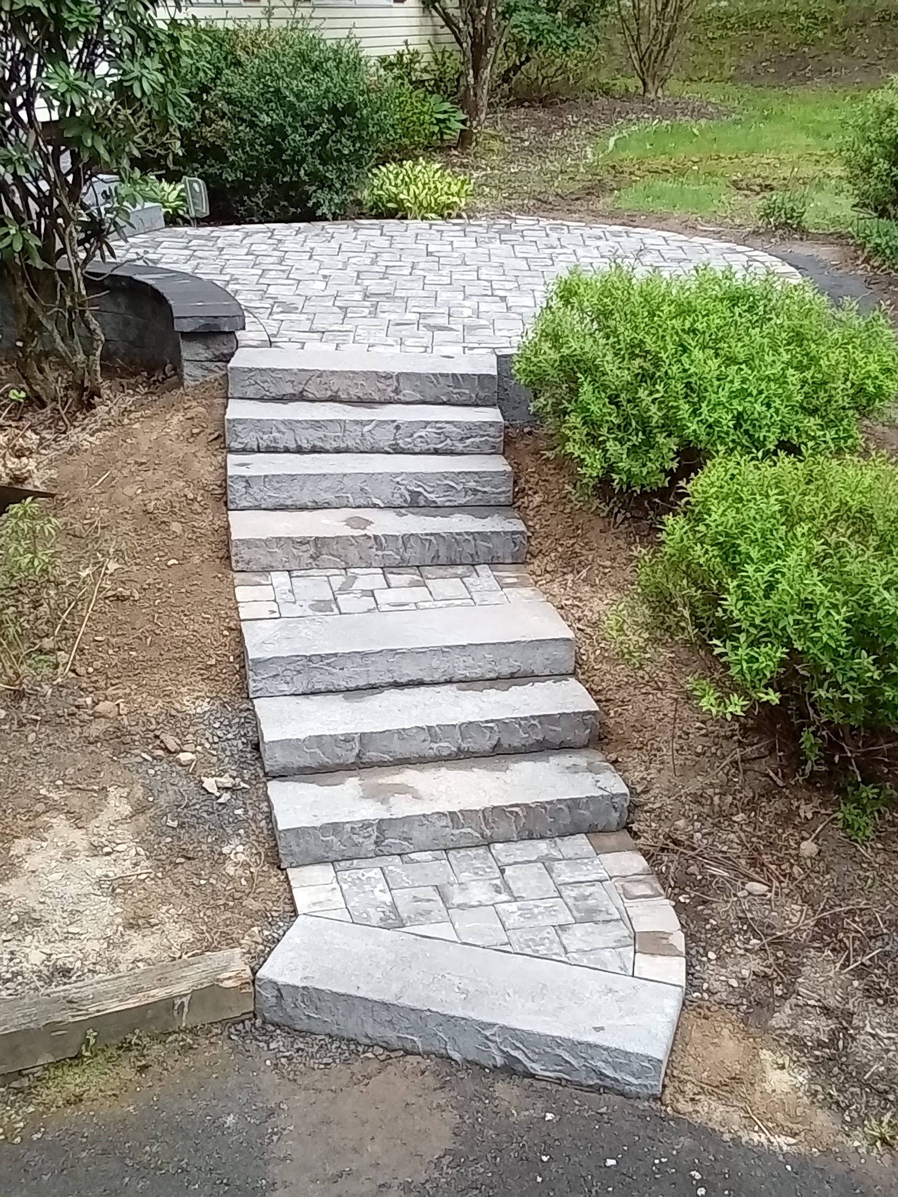 A set of stairs leading up to a house in a garden.