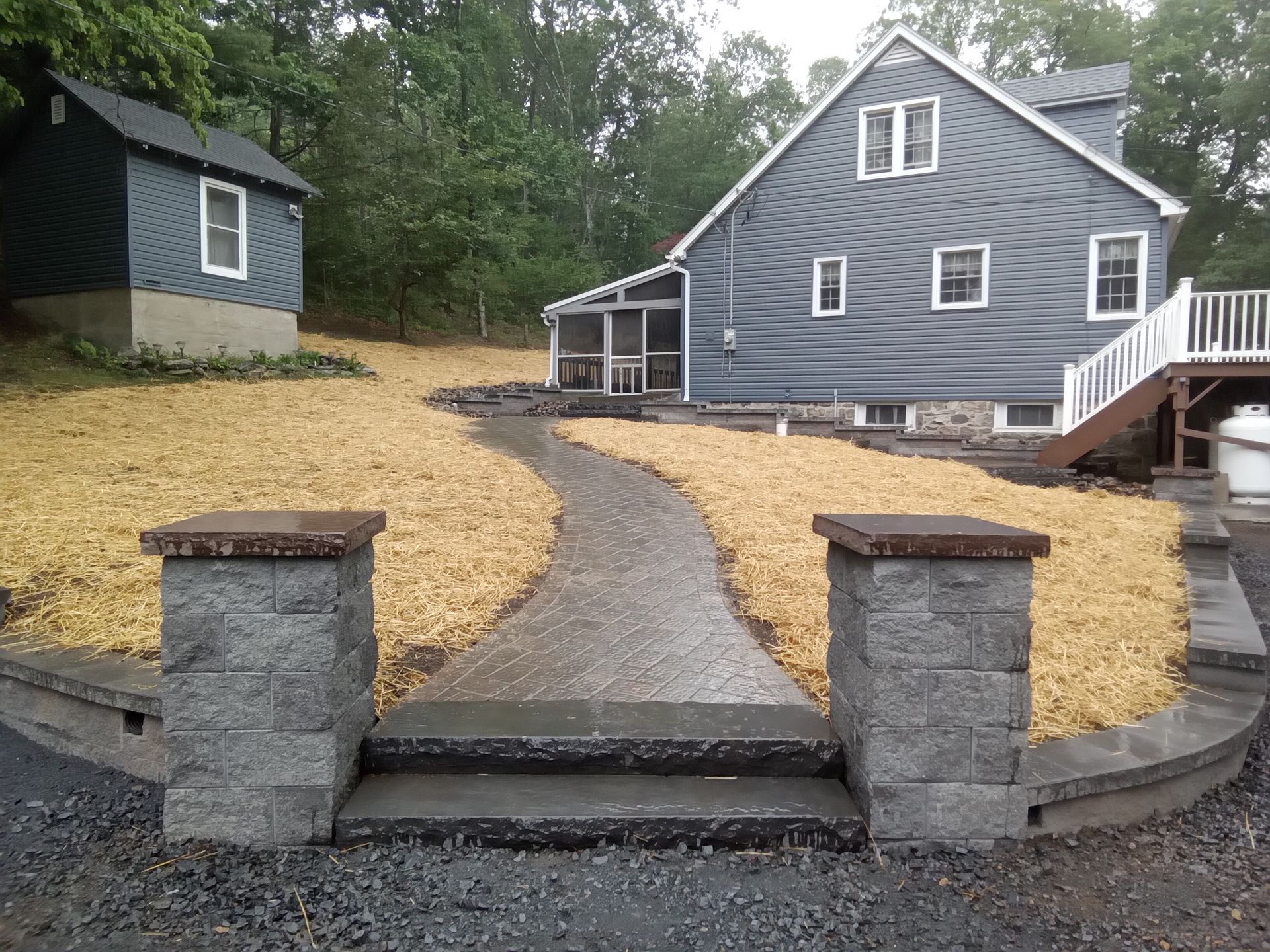 a brick walkway leading to the front door of a house .