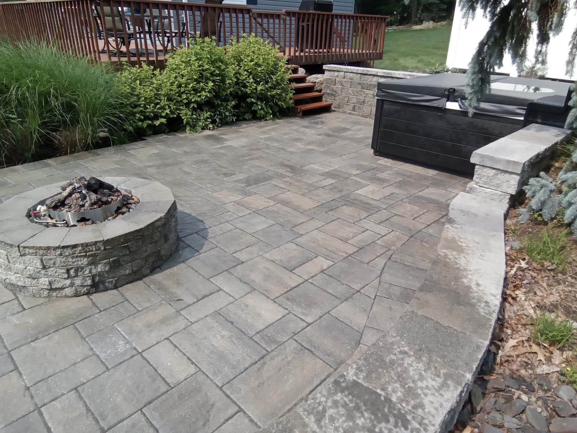 a patio with a black border is being built in front of a house .