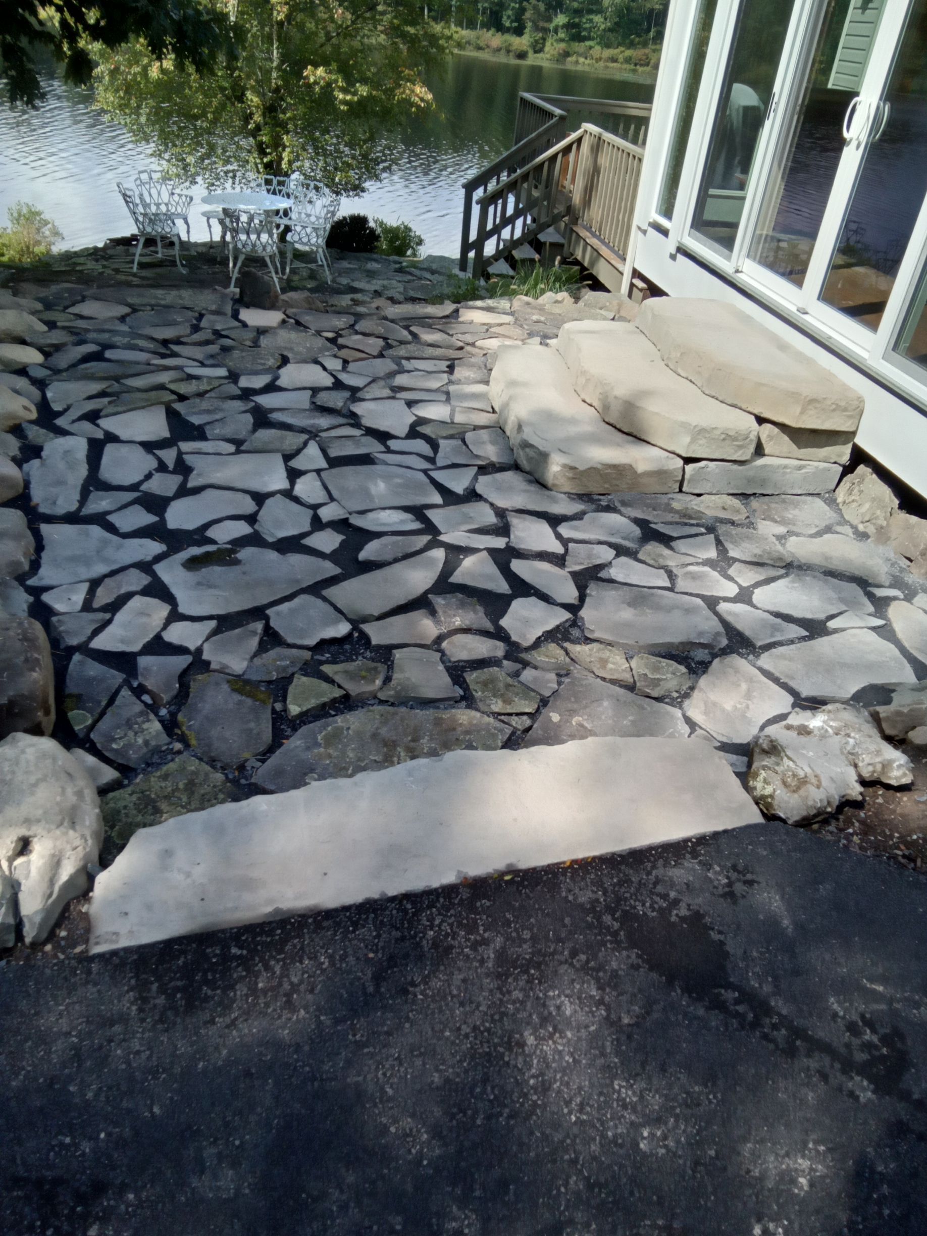 a white railing is being installed on the stairs of a brick house .
