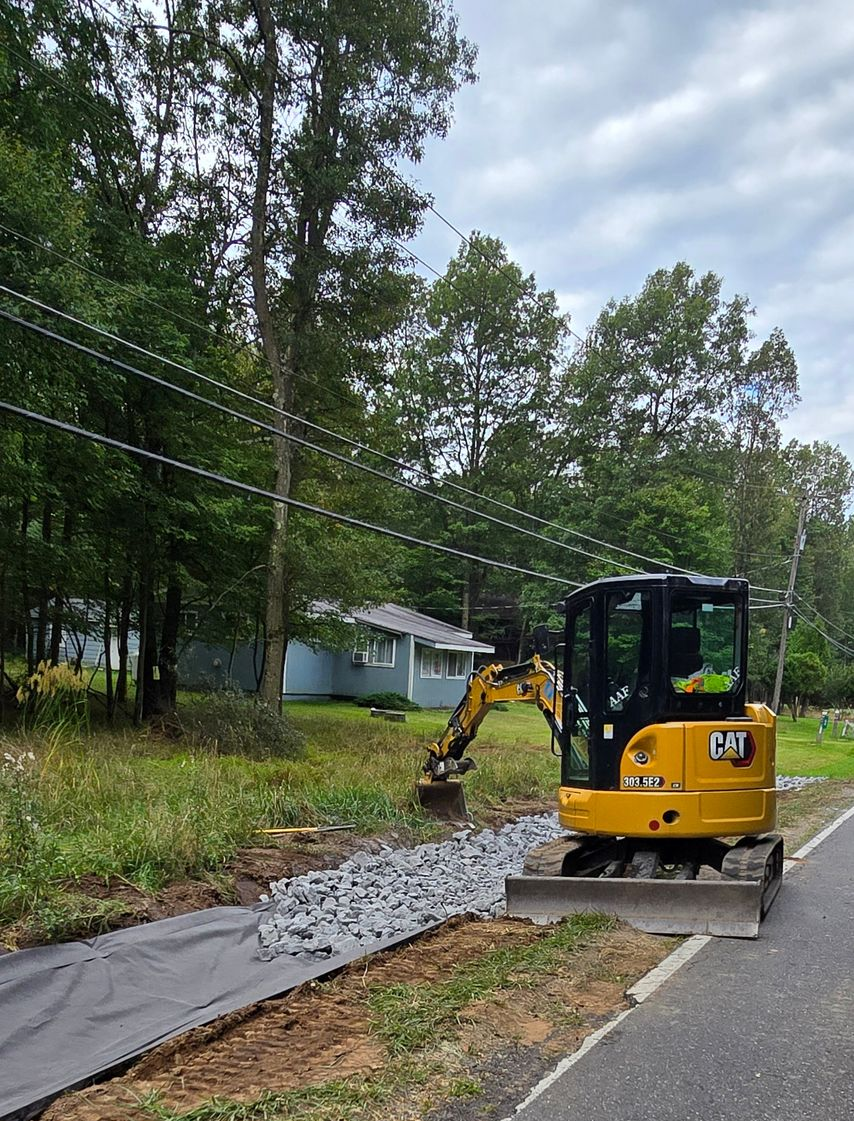 a garden with rocks and mulch in front of a commercial business