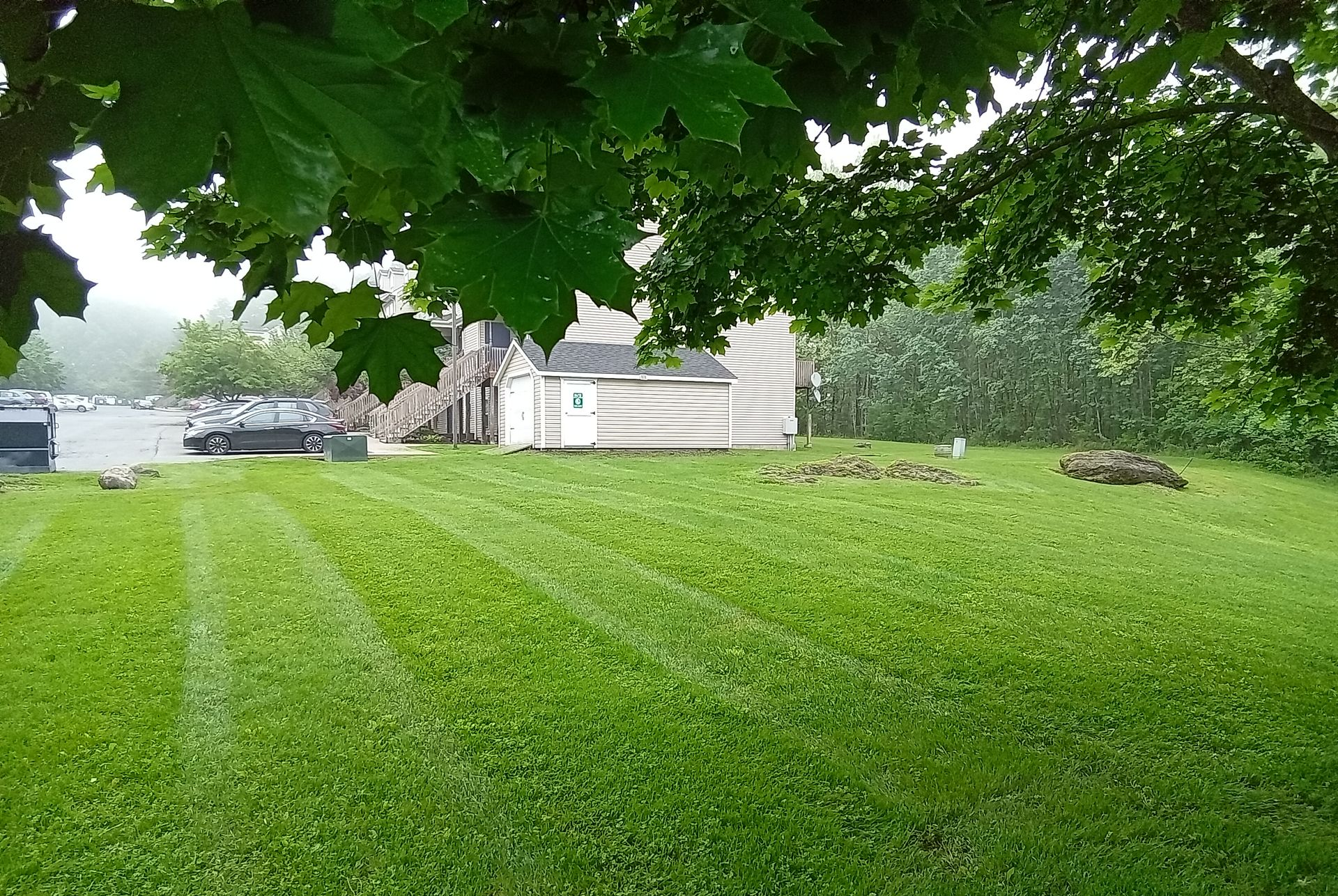 A white aaf landscaping truck is parked in a lush green field
