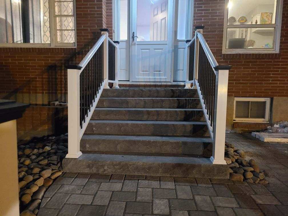 a brick house with stairs leading up to the front door