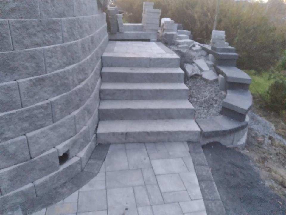 A set of stairs leading up to a brick wall.