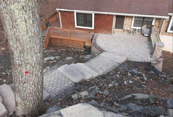 an aerial view of a house with a walkway leading to it