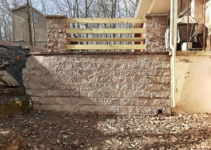 A brick wall is being built next to a house.