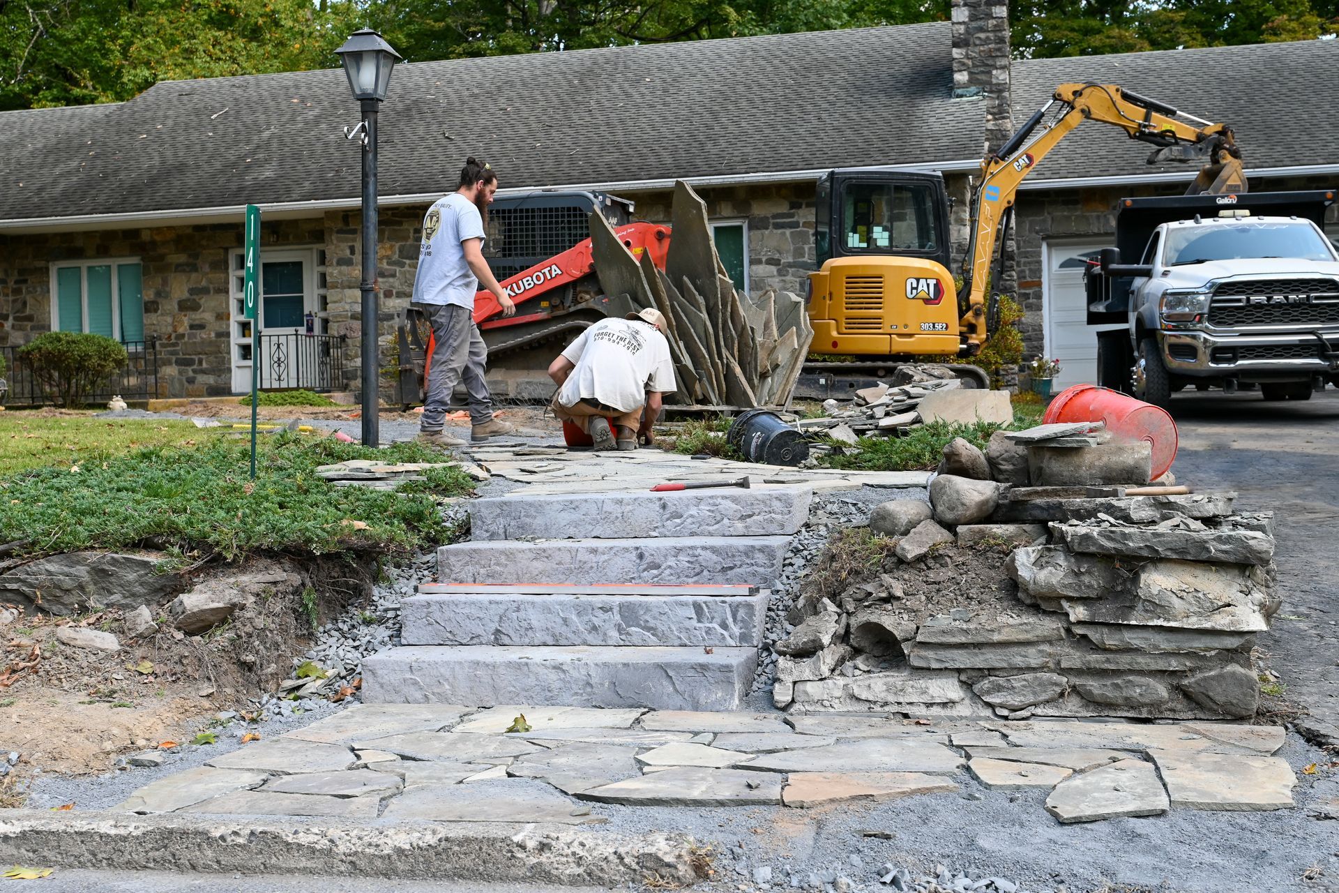 Stairs leading up to a house, hardscaping by A.A.F Landscaping