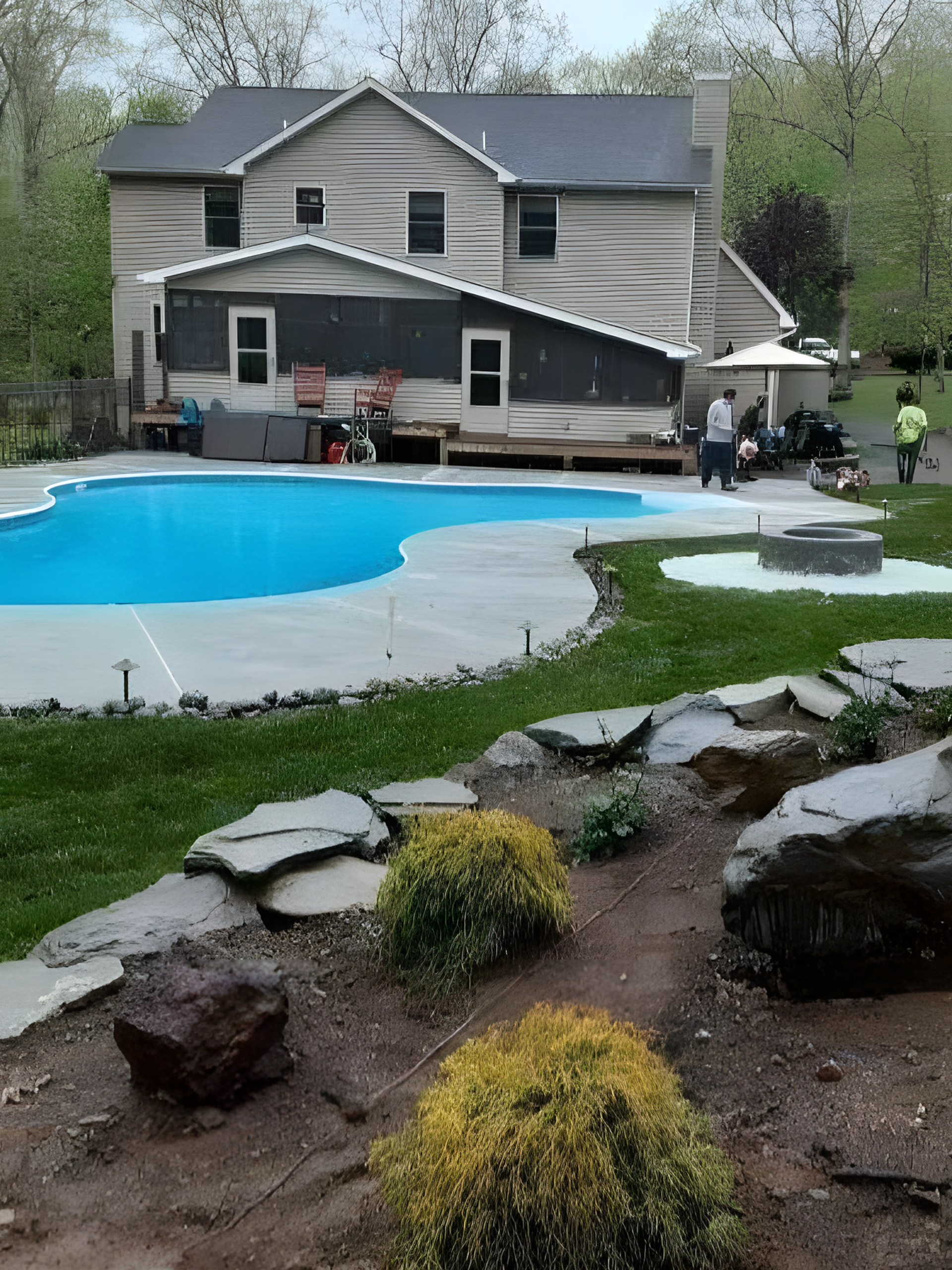 a large house with a large swimming pool in the backyard and landscaping done by A.A.F Landscaping