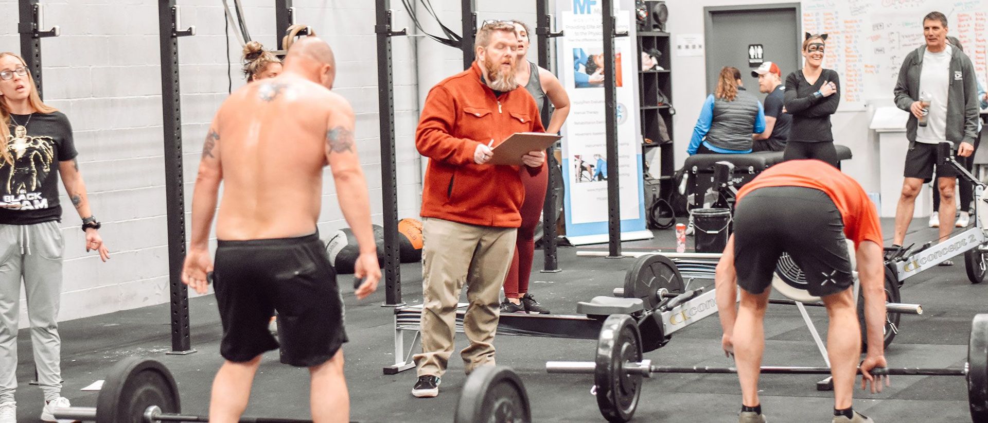 A group of men are lifting weights at CrossFit Garage gym in Woodstock, GA