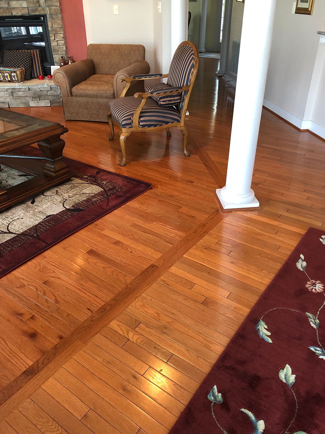 A living room with hardwood floors and a fireplace