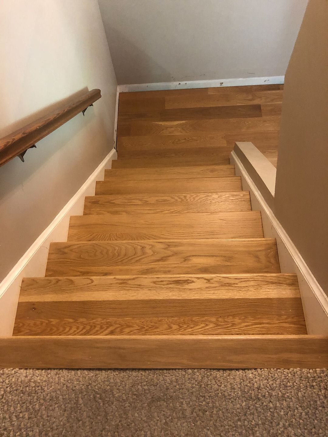 A set of wooden stairs leading up to the second floor of a house.