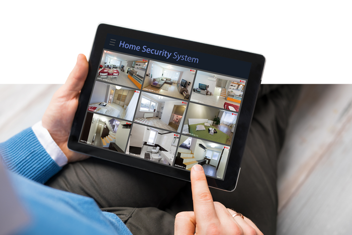 Man Using Tablet for Home Security System
