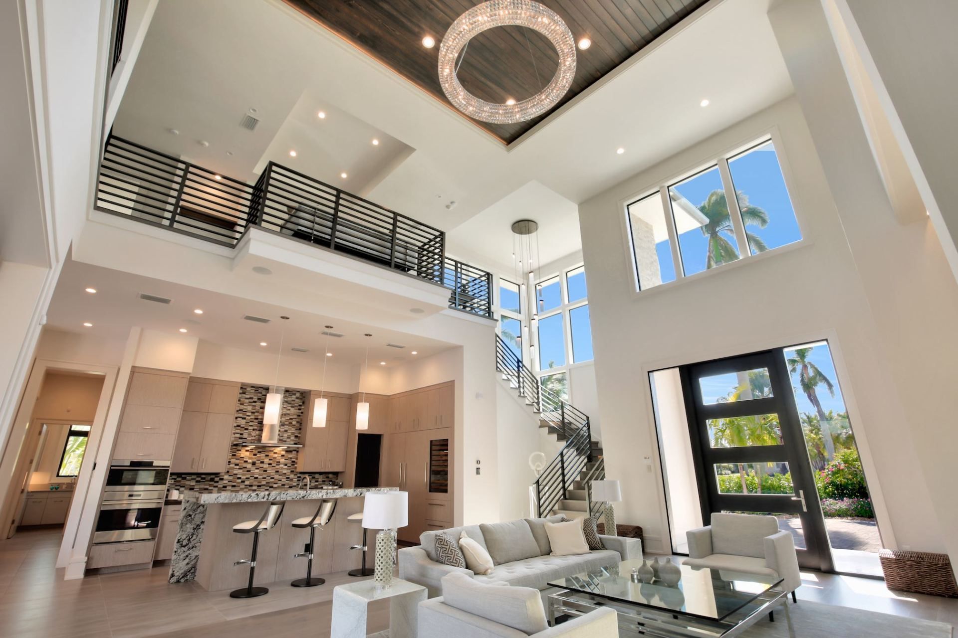 Modern luxury living room with a spiral staircase and high ceilings.
