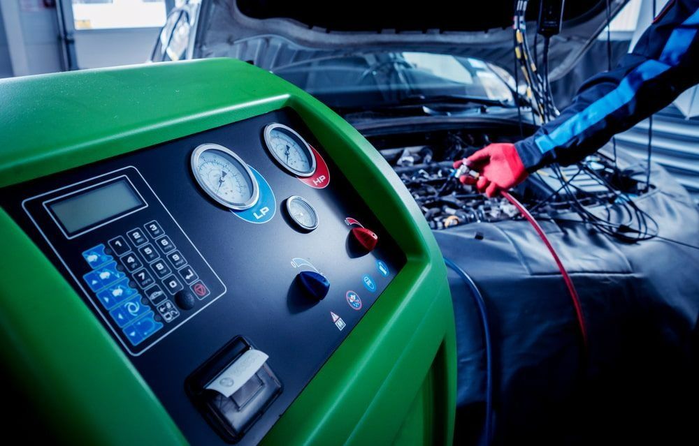 Mechanic Uses an Air Conditioning Service Machine — Barnco Automotive Repairs in Taminda, NSW