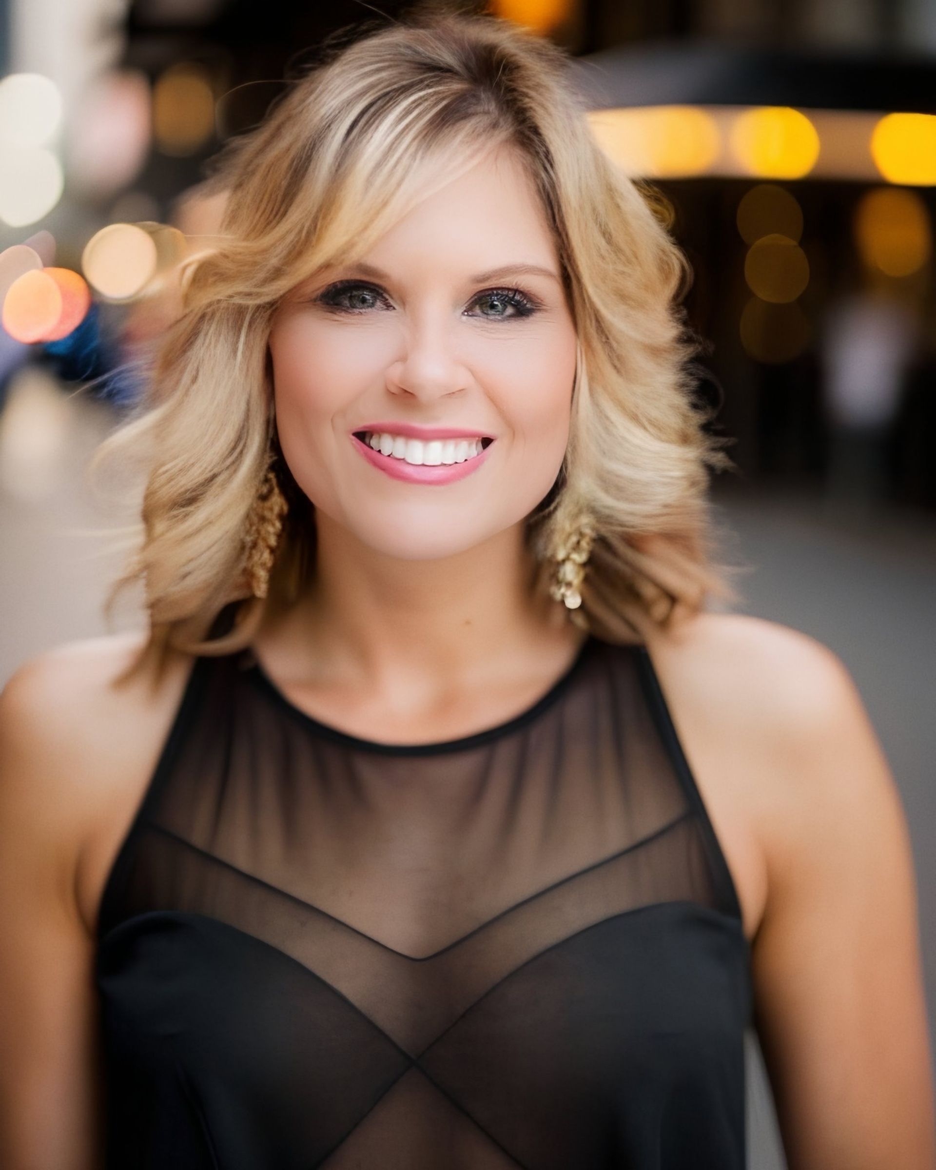 Lady Jen Du Plessis  in a black dress is smiling for the camera