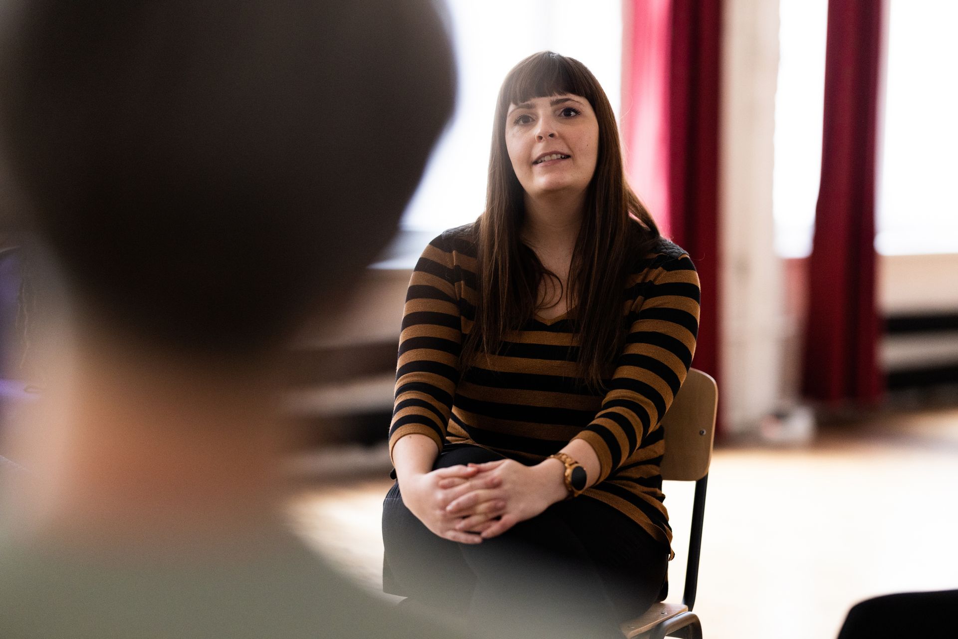 A therapist talking with people during mental health therapy A therapist talking with people during mental health therapy