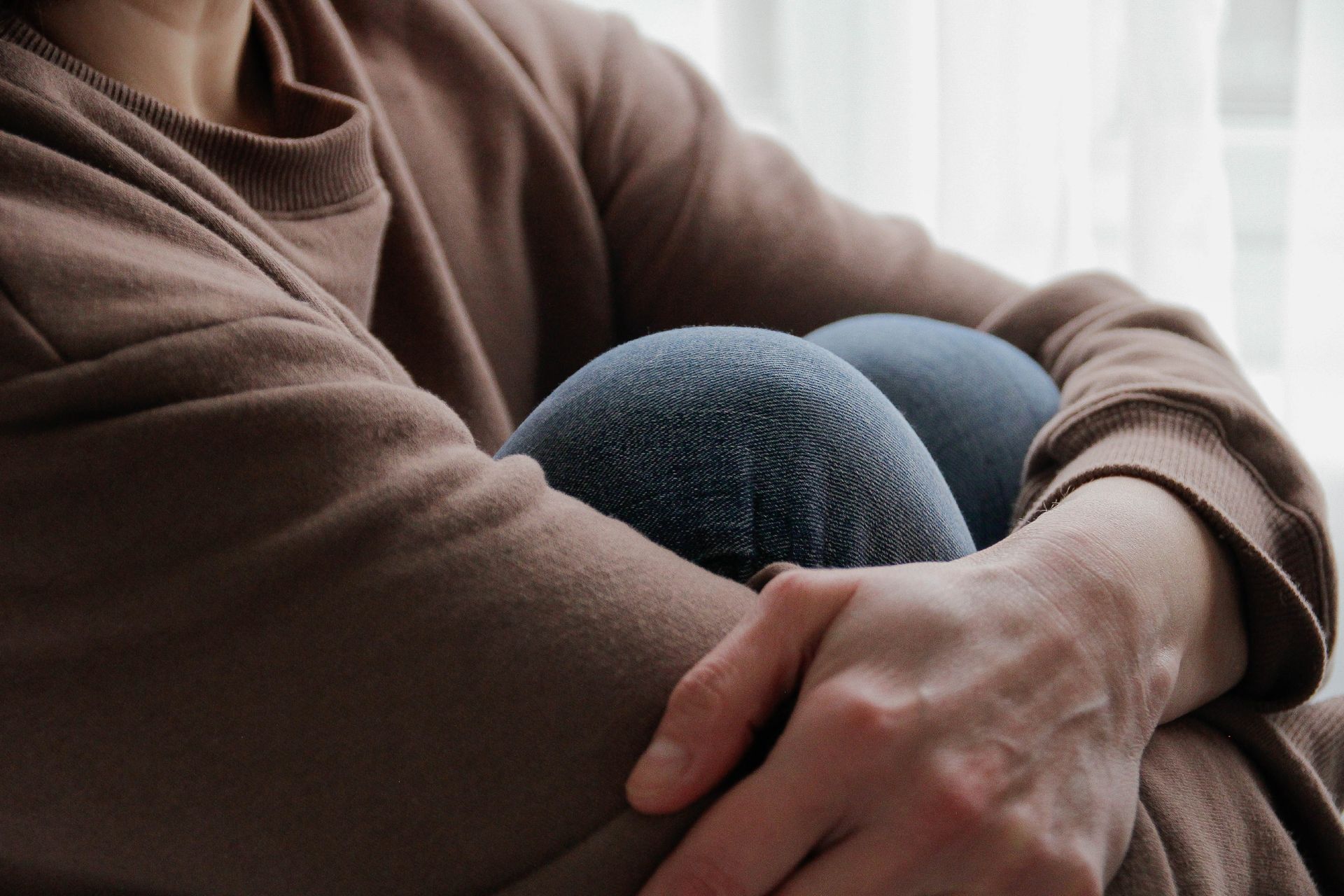 Man holding knees