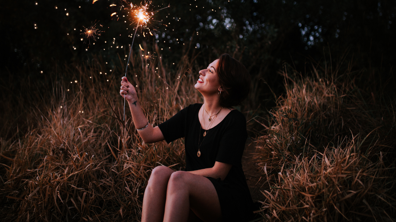 A bunch of pills and a yellow flower on a yellow background.