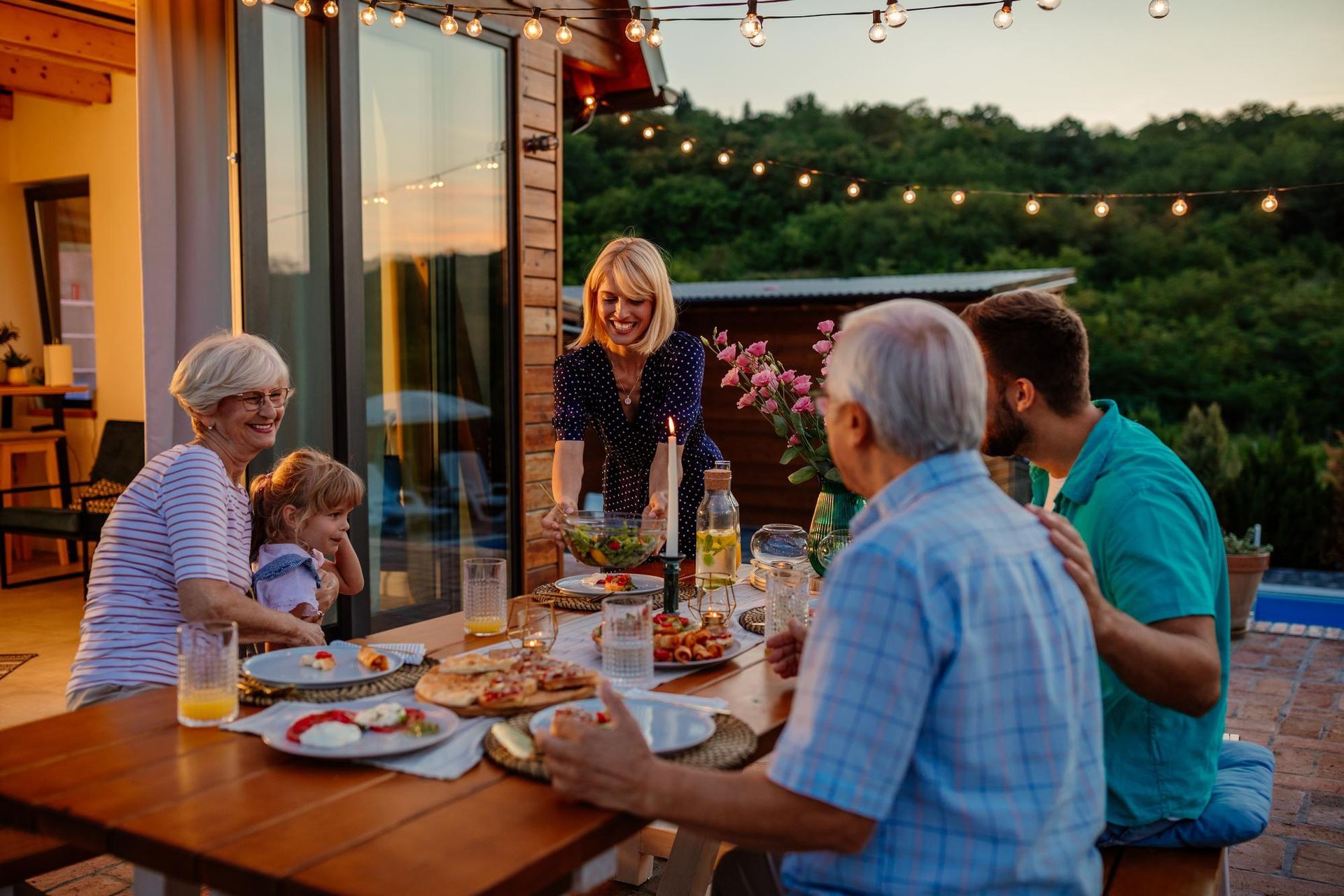 A family is sitting at a table eating food.