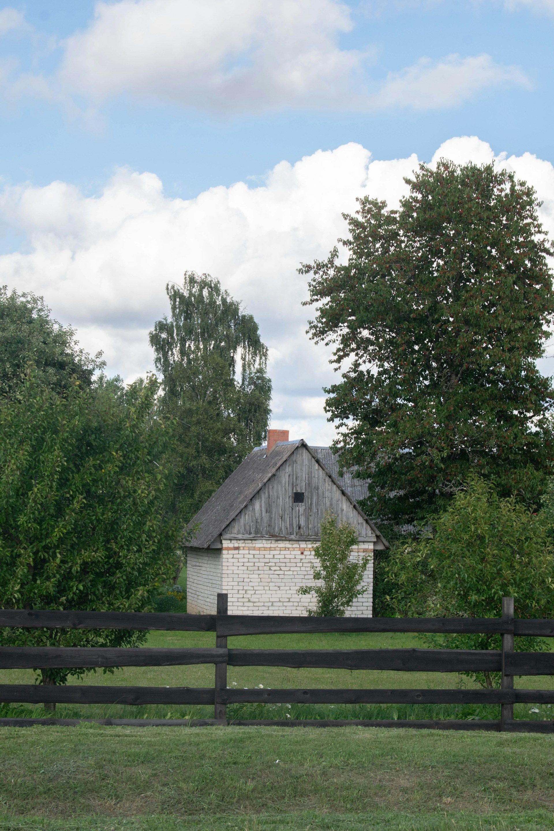 A group of people are hugging each other on the porch of a house.