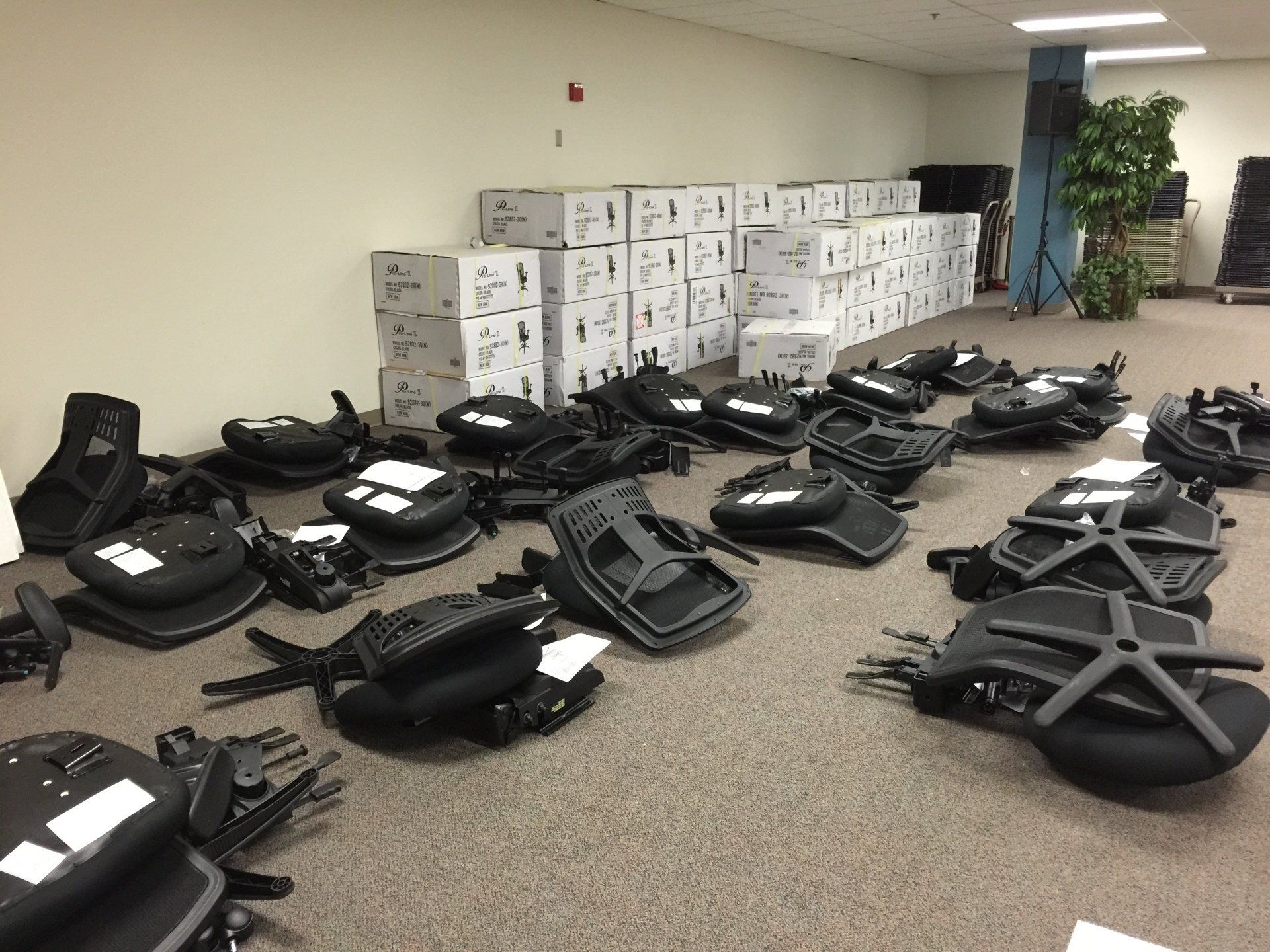 Numerous unpacked office rolling chairs