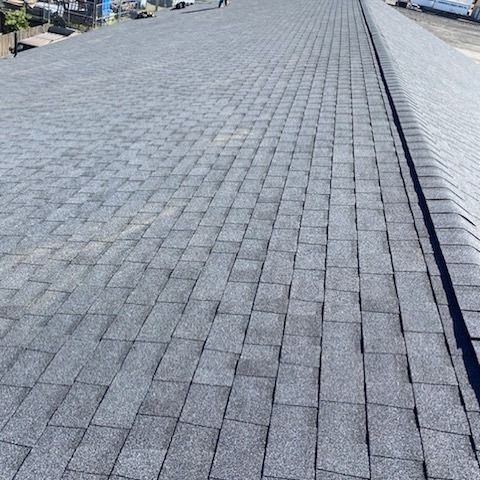 Close-up view of a dark gray asphalt shingle roof.