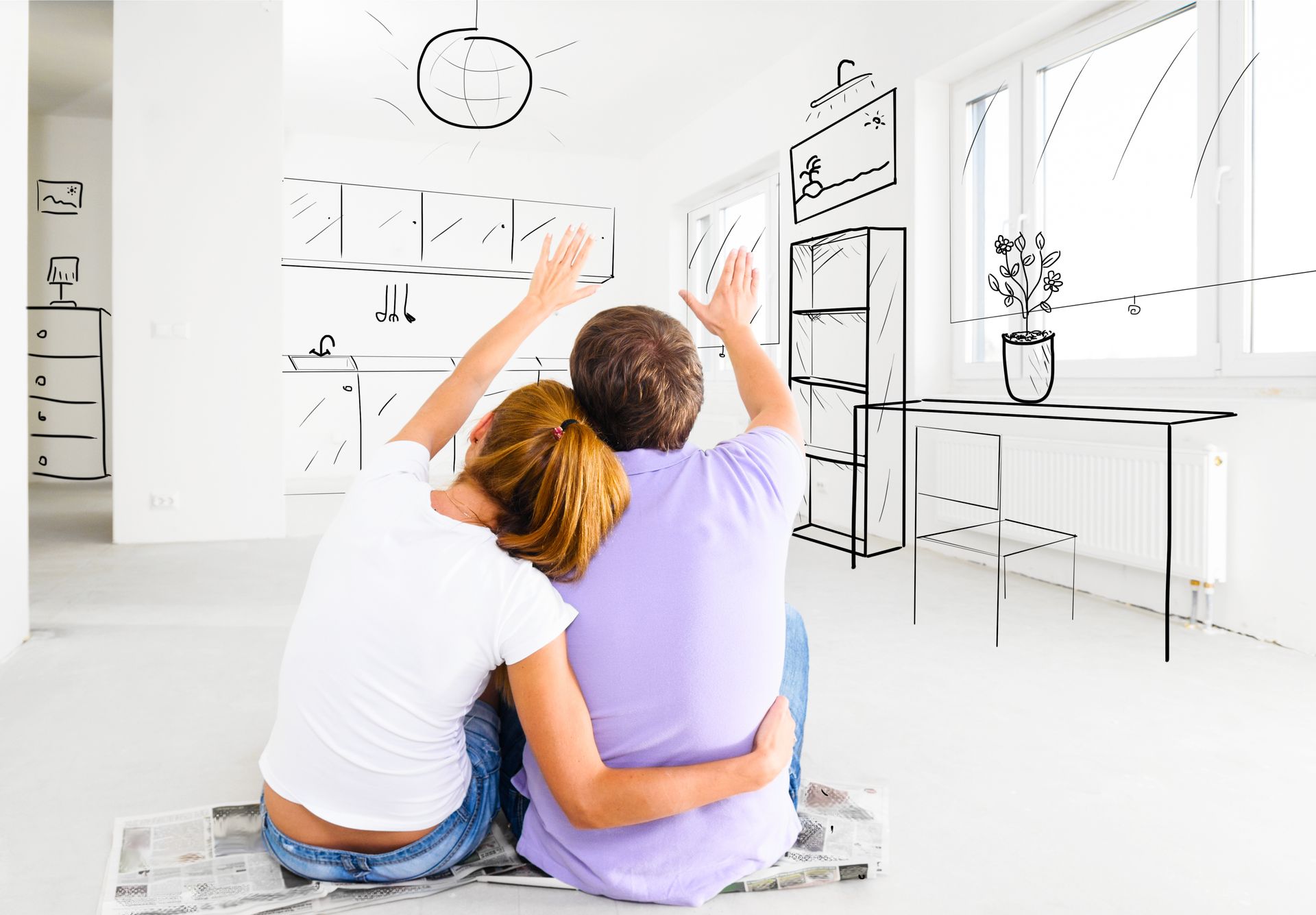 Couple embracing, raising hands, envisioning a home's design with sketched kitchen, living room details on white walls.