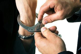 Police unlocking handcuffs off detainee
