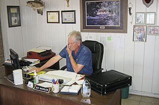 Bail bond agent on the phone at desk