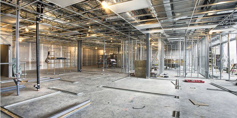 The inside of a building under construction with a lot of metal frames.