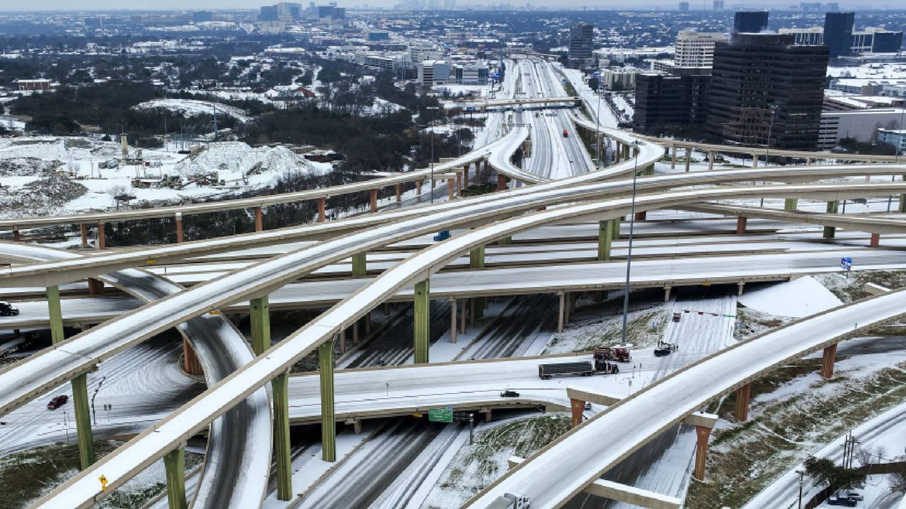 An aerial view of a highway intersection covered in snow.