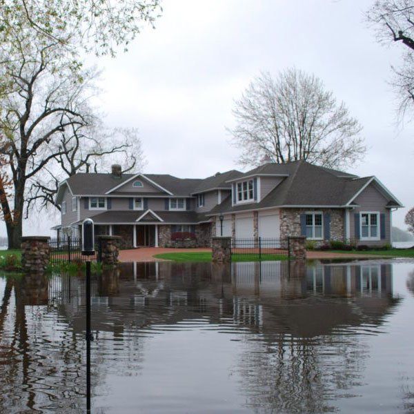a large house is surrounded by flood water