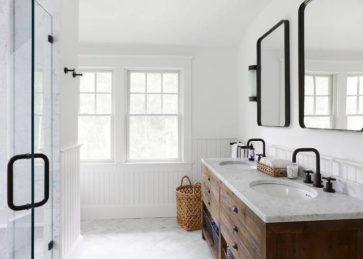 A bathroom with two sinks and two mirrors.