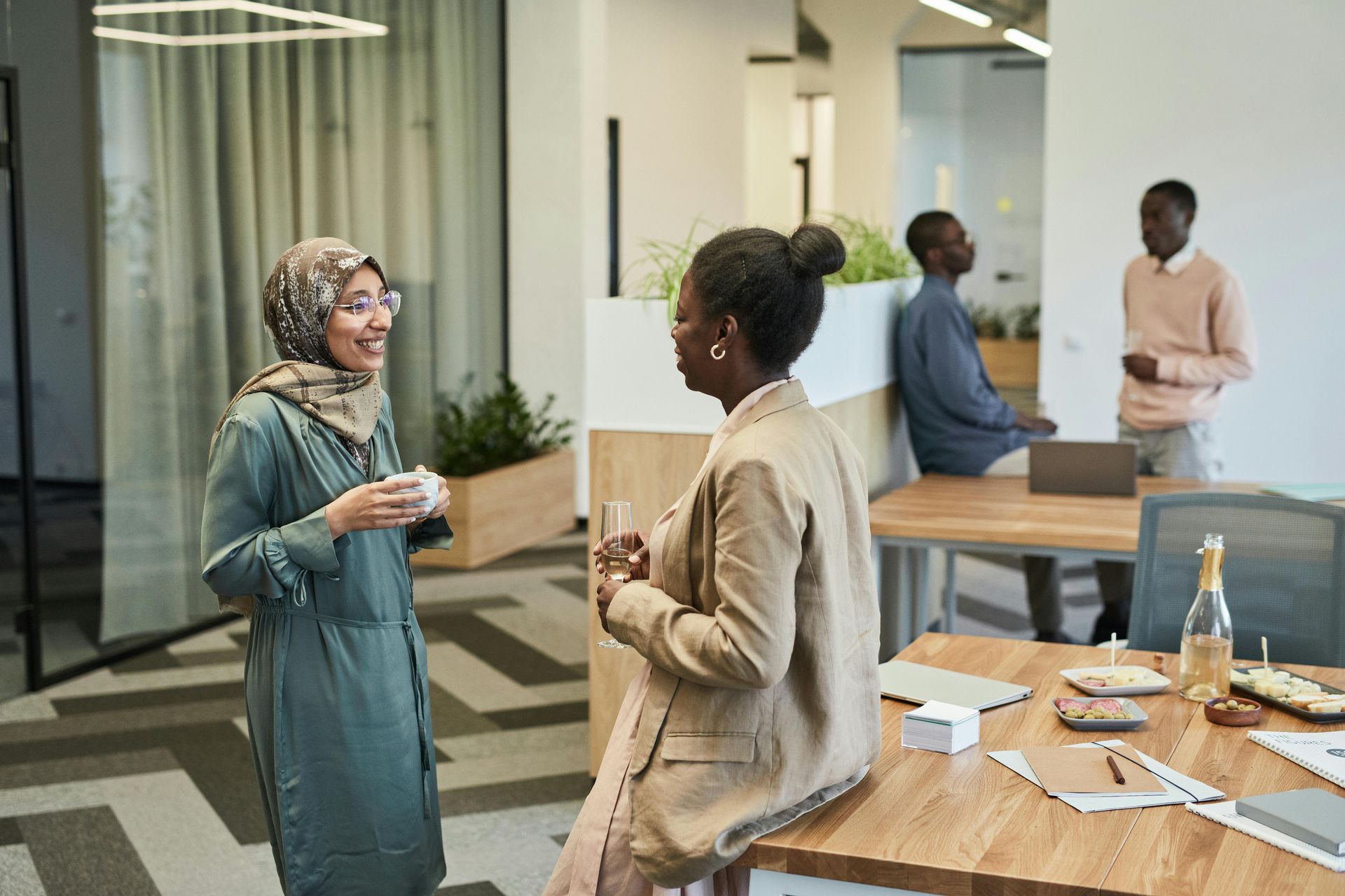 Two women are talking to each other in an office.