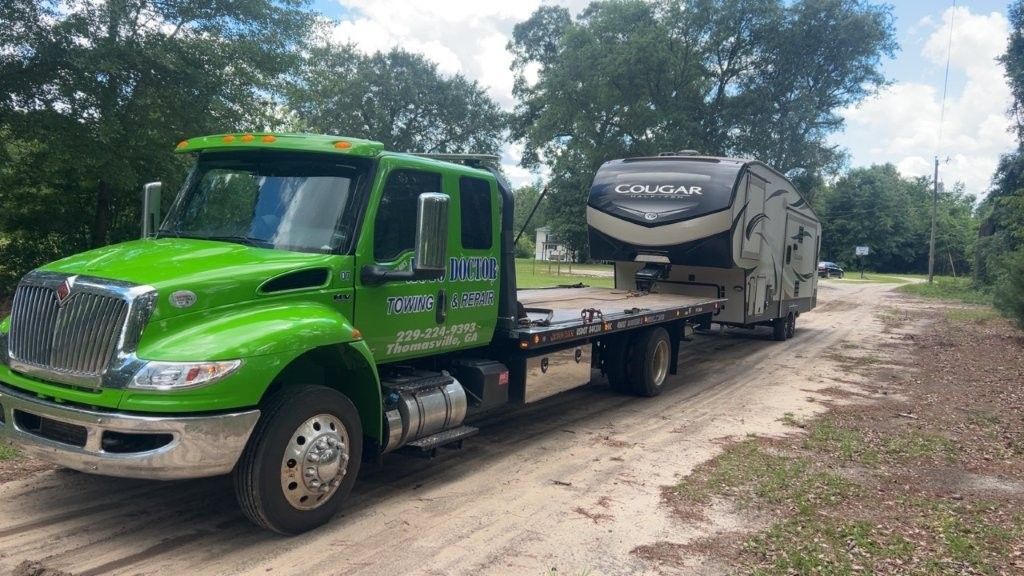 Tow truck with camper attached 