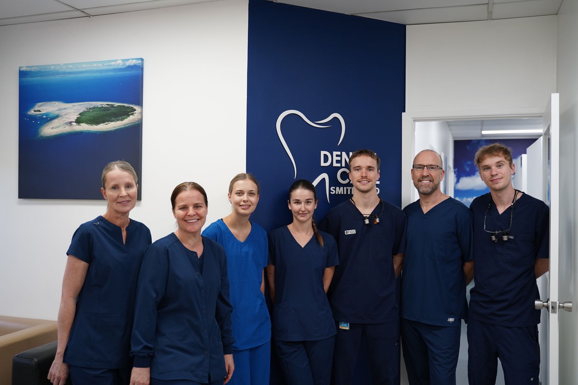 A Group Of Dentists Are Posing For A Picture In A Dental Office — Dental Care Smithfield In Smithfield, QLD