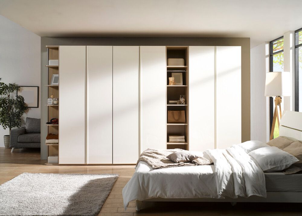 A bedroom with a bed and a large wardrobe — Bruce Smith Cabinets in Pottsville, NSW