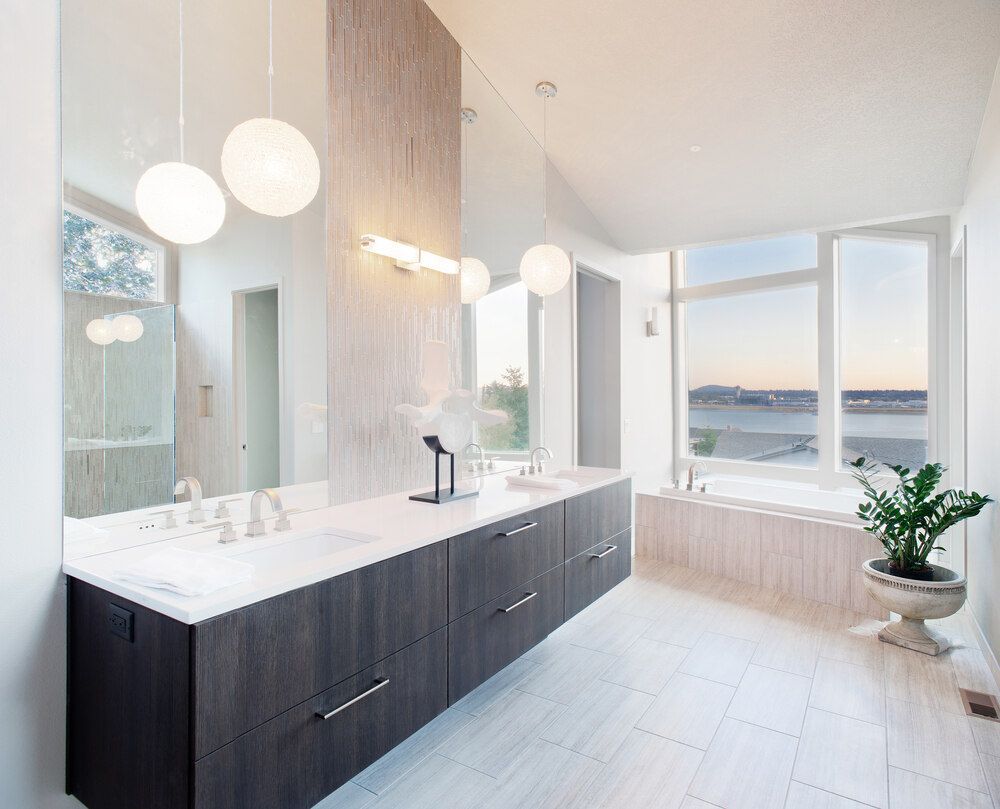 A Bathroom With Two Sinks, a Tub and a Large Mirror — Bruce Smith Cabinets in Bray Park, NSW