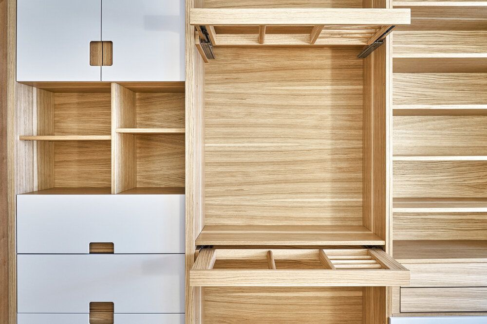 A Close Up of an Empty Wooden Closet With Drawers and Shelves — Bruce Smith Cabinets in Bray Park, NSW