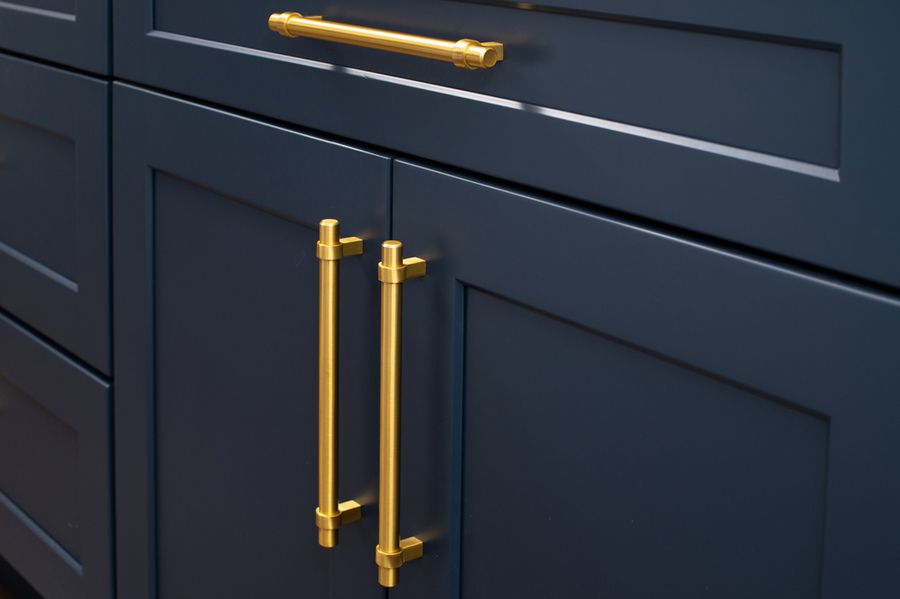 A Close Up of a Blue Cabinet With Gold Handles — Bruce Smith Cabinets in Kingscliff, NSW