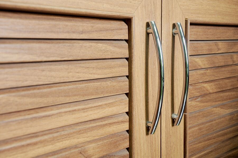 A Close Up of a Wooden Cabinet With Metal Handles — Bruce Smith Cabinets in Pottsville, NSW