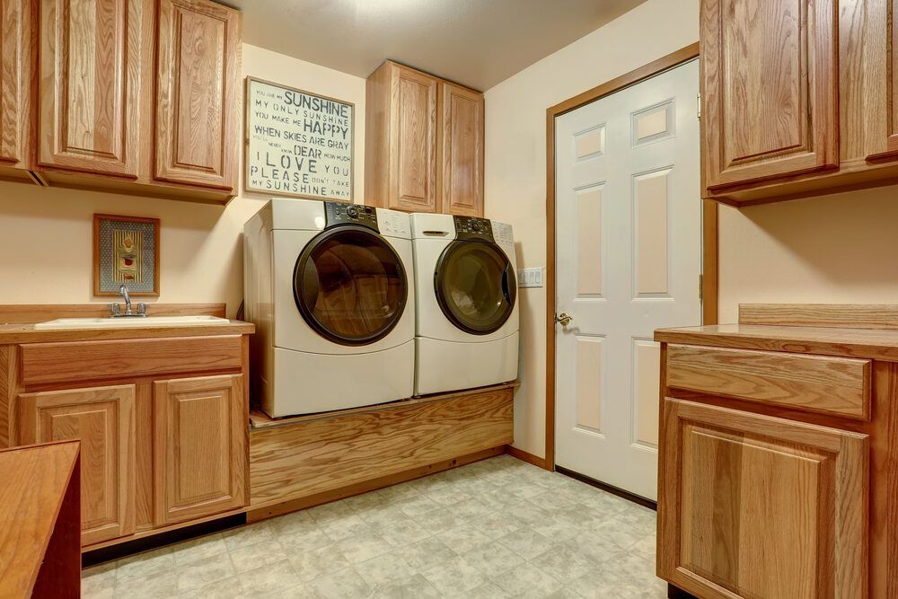 A Laundry Room With Two Washer and Dryer — Bruce Smith Cabinets in Bray Park, NSW