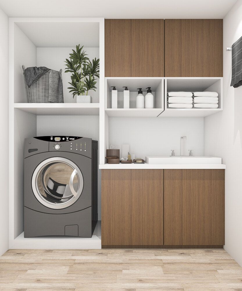 A Laundry Room With a Washer and Dryer and Wooden Cabinets — Bruce Smith Cabinets in Bray Park, NSW