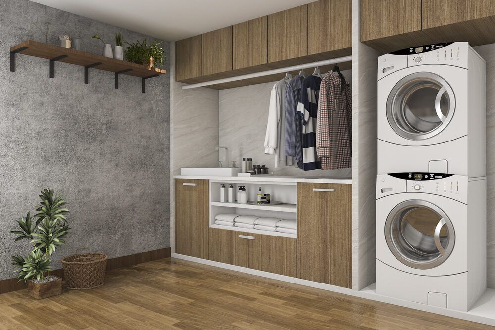 A Laundry Room With a Washer and Dryer Stacked on Top of Each Other — Bruce Smith Cabinets in Pottsville, NSW