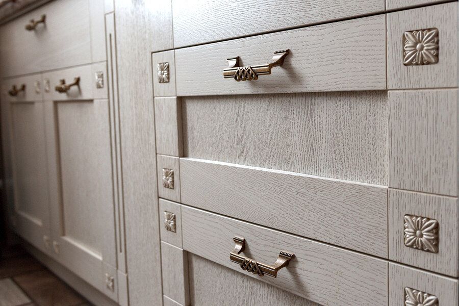 A Kitchen With White Cabinets and Drawers With Gold Handles — Bruce Smith Cabinets in Byron Bay, NSW