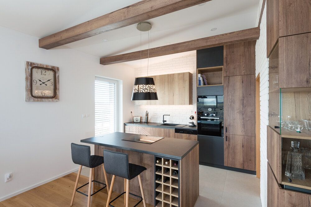A Kitchen With a Wine Rack and a Clock on the Wall — Bruce Smith Cabinets in Byron Bay, NSW